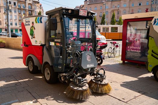 The vehicle washes the streets and cleans the pedestrian zone of the city. Budapest, Hungary - 08.25.2022