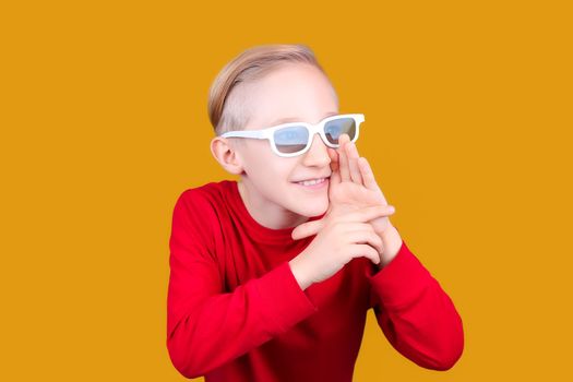 a child in 3D glasses puts his hand to his mouth and screams