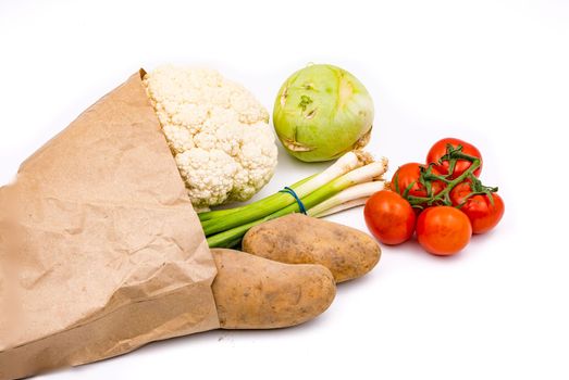 Fresh organic vegetables in a sustainable grocery bag isolated with focus stacking against a white background