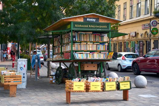 A bookstall from an old cart on a city street. Budapest, Hungary - 08.25.2022