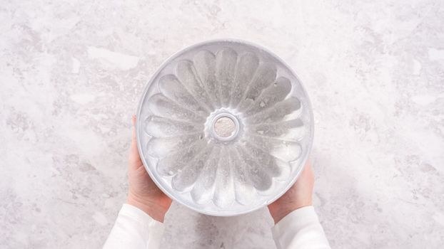 Flat lay. Step by step. Greasing bundt cake pan with vegetable shortening and sprinkling with white flour.
