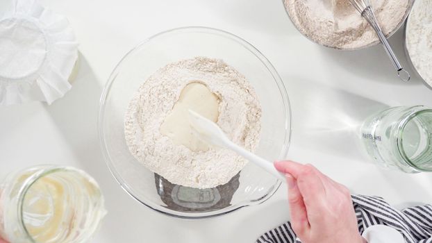 Flat lay. Measuring ingredients into a glass bowl to bake cinnamon rolls.