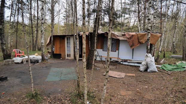 Homemade homeless dwelling next to a landfill