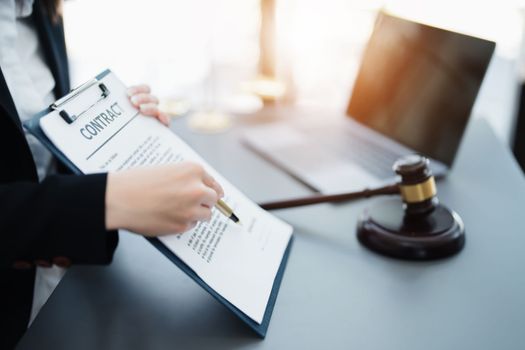 The lawyer with a client discussing contract paper, a Business lawyer working about legal legislation in the courtroom to help their customer, contract and agreement concept