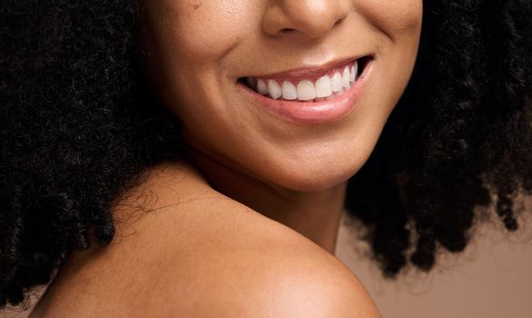 Face beauty, dental and teeth of black woman in studio isolated on a brown background. Skincare, makeup and cosmetics of happy female model with veneers, teeth whitening and invisalign for wellness