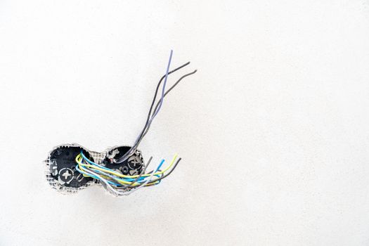 holes and wires in the wall for sockets and switches. High quality photo