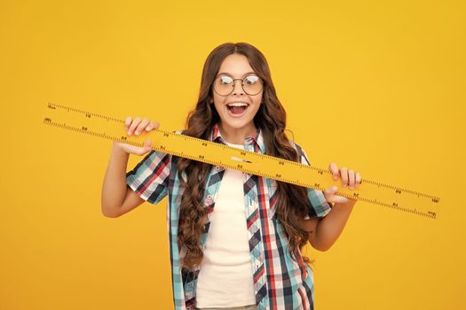 Back to school. Teenager school girl on yellow isolated background. School supplies