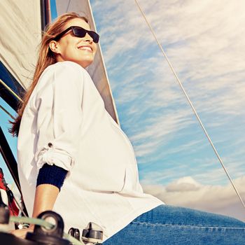 Smile, vacation and woman on a yacht to relax, cruise and sailing at sea in Italy. Peace, adventure and person on a luxury boat for a holiday in summer on the water for happiness and ocean travel.