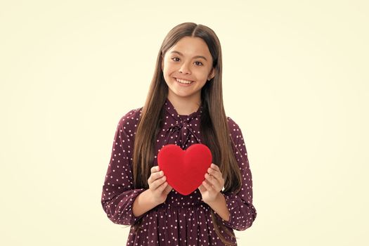 Valentines Day. Dreaming cute teen child with red heart. Portrait of happy smiling teenage child girl
