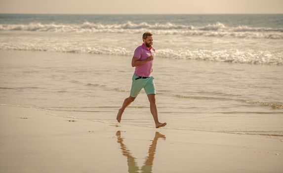 adult sporty man runner sprinting on beach outdoor, achievement.