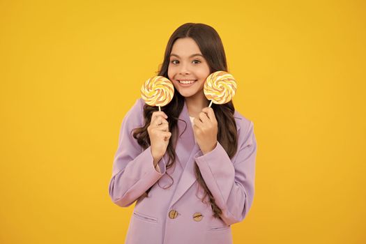 Teenage girl with lollipop, child eating sugar lollipops, kids sweets candy shop. Excited teenager girl. Happy teenager, positive and smiling emotions of teen girl