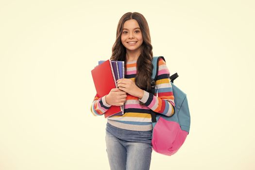 School teenager child girl with school backpack hold book and copybook. Teenager student, isolated background. Learning and knowledge. Go study. Happy girl face, positive and smiling emotions