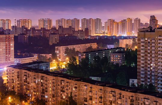 Night colorful windows lights of the high-rise residential building in city sleeping area