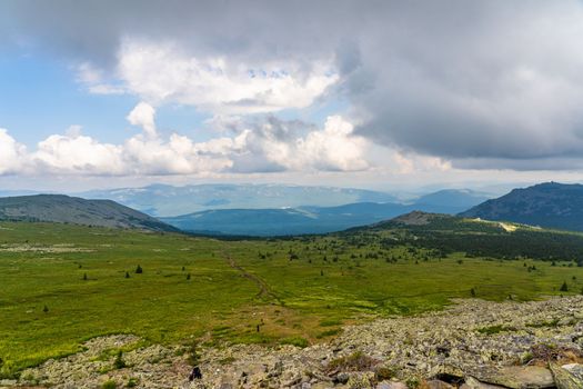 Forests and mountains of the Southern Urals near the village of Tyulyuk in Russia. Drone view