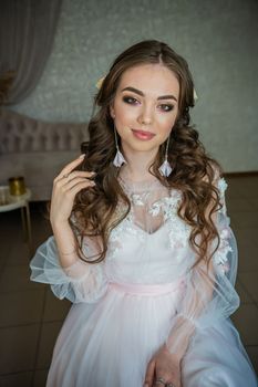 Beautiful festive make-up on a girl in a white dress