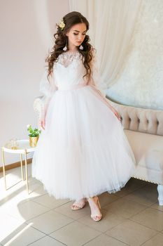 Girl model in a white festive dress