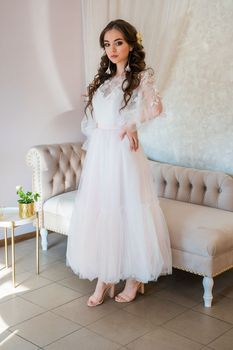 Girl model in a white festive dress