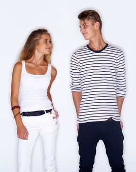 Fashion fever. Young trendy couple standing together on white background
