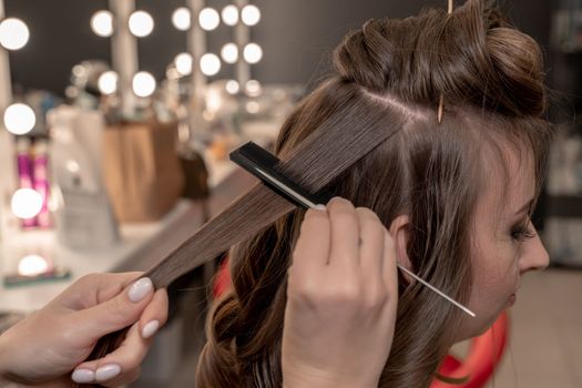 hairdresser coiffeur makes hairstyle Closeup.