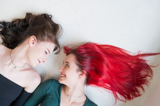 Top view of two women lying side by side. Lesbian intimacy