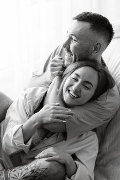 earlier morning bride and groom at home in bed