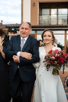 wedding ceremony of the newlyweds on the pier near the restaurant