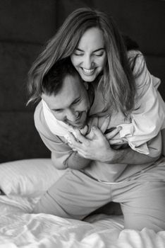 earlier morning bride and groom at home in bed