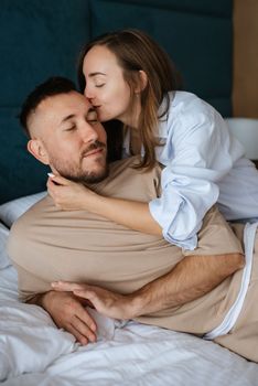 earlier morning bride and groom at home in bed