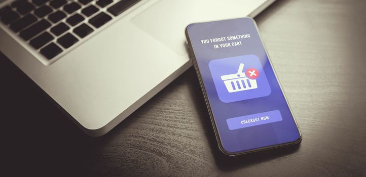 Abandoned Shopping Cart Recovery using Email Marketing Strategies. Smartphone with open email reminder message, effectiveness of targeted email in boosting sales, recovering abandoned shopping carts.