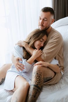 earlier morning bride and groom at home in bed