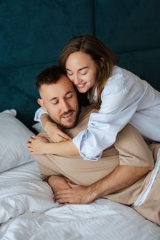 earlier morning bride and groom at home in bed