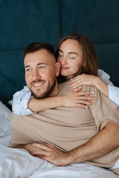 earlier morning bride and groom at home in bed