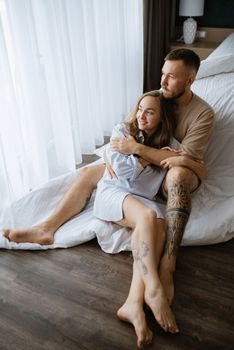 earlier morning bride and groom at home in bed