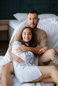 earlier morning bride and groom at home in bed