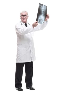 full-length. qualified mature doctor looking at the x-ray. isolated on a white background.