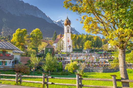 Grainau Church at golden autumn sunrise and Zugspitze massif, Bavarian alps , Germany