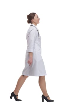 female doctor with a stethoscope striding forward . isolated on a white background.