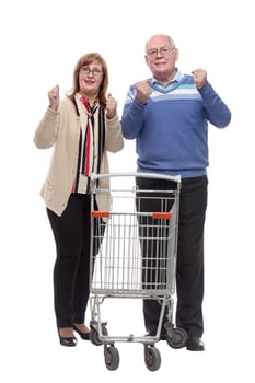 in full growth. casual elderly couple with shopping cart. isolated on a white
