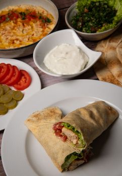 Lebanese recipe of chich taouk, garlic cream, toum, in a Lebanese bread, tabbouleh and chickpea puree, hummus High quality photo