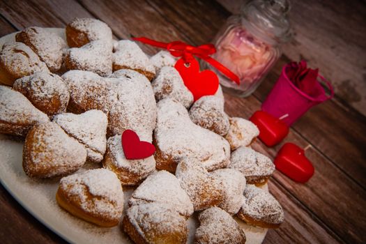 Recipe for soft heart-shaped doughnuts for Valentine's Day. High quality photo