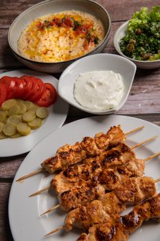 Lebanese recipe of chich taouk, garlic cream, toum, in a Lebanese bread, tabbouleh and chickpea puree, hummus High quality photo