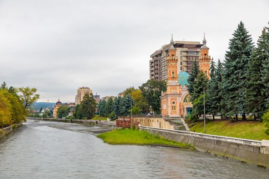 Terek river in Vladikavkaz. Urban landscape. Church and modern buildings
