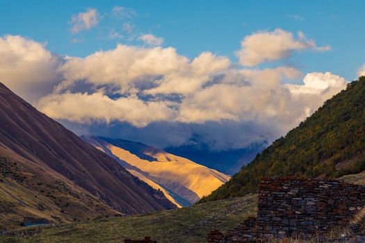 Highlands of North Ossetia. Mountains of the Caucasus. High mountains in the rays of the setting sun