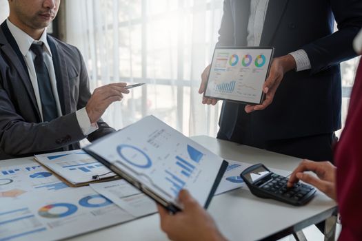 Close up of Diverse colleagues gather brainstorm discuss financial statistics at office meeting. finance, teamwork, Big data Graphs Charts concept.