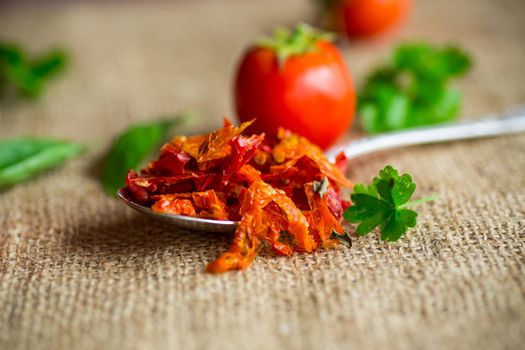 small pieces of dried tomatoes next to fresh tomatoes, natural homemade spices