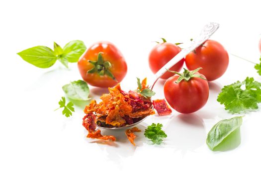 small pieces of dried tomatoes next to fresh tomatoes, natural homemade spices