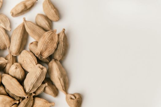 Cardamon seeds on a white background.