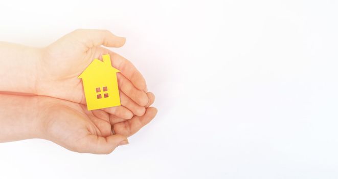 hands holding paper house, family home, homeless housing, mortgage crisis and home protecting insurance concept, foster home care, family day care, social distancing