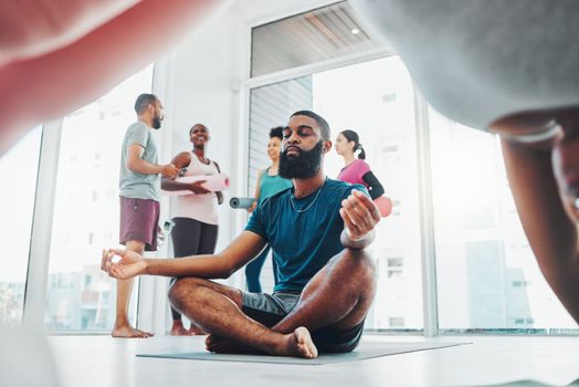 Yoga, meditation and black man do lotus exercise for fitness, peace and wellness in class. Young sports person in health studio for holistic workout, mental health and body balance with zen energy.