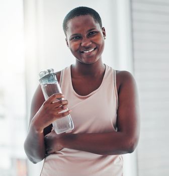 Portrait, black woman and exercise with water bottle, smile and training for wellness, balance or healthy lifestyle. Face, African American female athlete or lady with liquid, happiness and hydration.